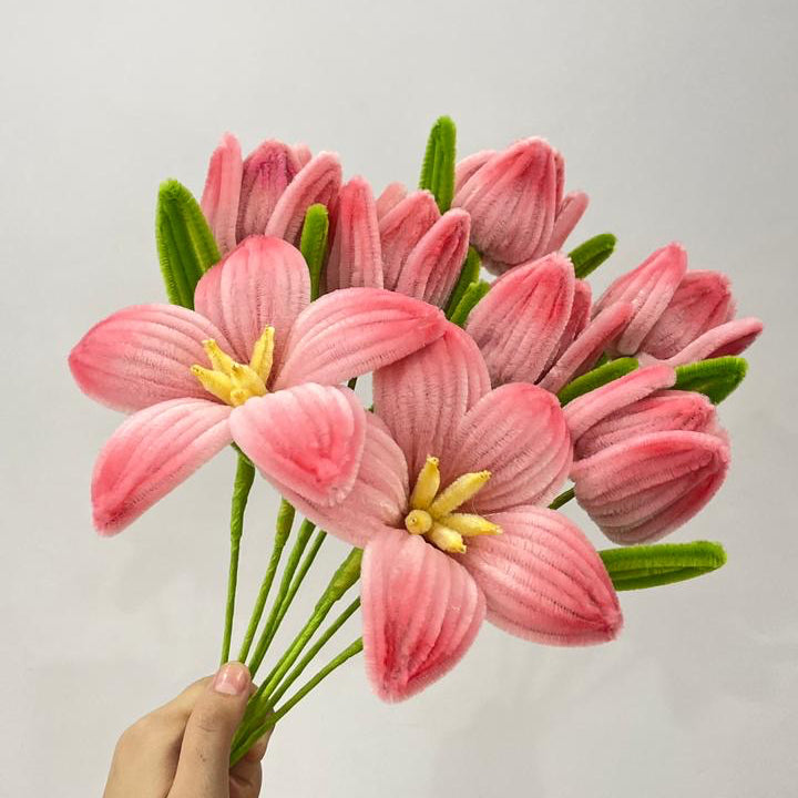 Tulips and lilies finely made with high quality pipe cleaners held in a plain background