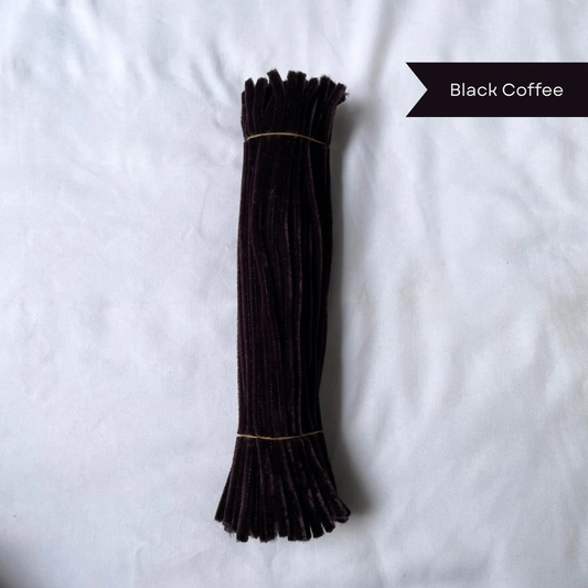 A bundle of black coffee color pipe cleaners on a white background with 'Black Coffee' label available in 50 piece and 100 piece packs