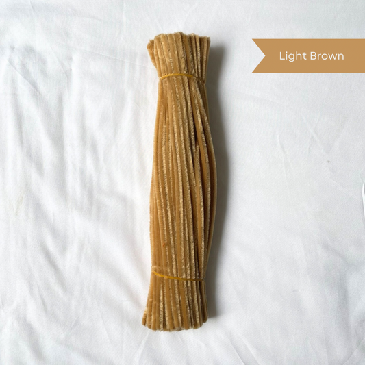 Light brown pipe cleaners on a white background with a label indicating 'Light Brown' available in 50 piece or 100 piece packs.