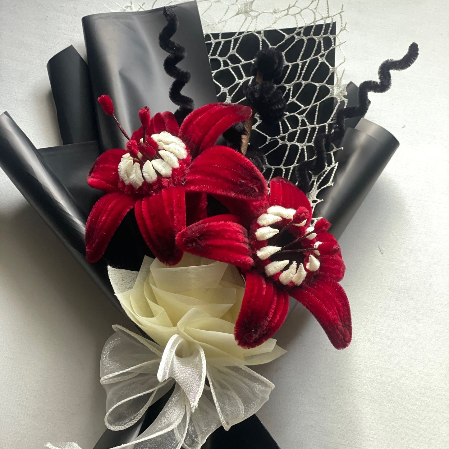 Red and white lilies inspired by stranger things demogorgon in a black wrapping